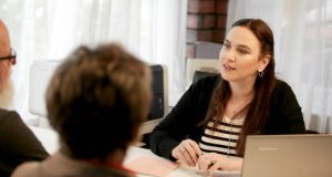 Tax accountant Nadine Rawlings with clients discussing their financial plans.